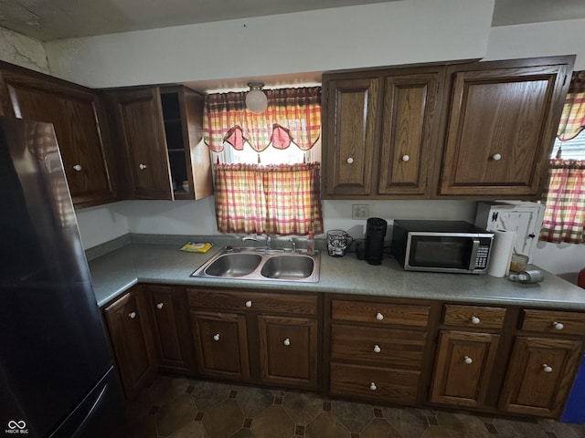 kitchen with sink, dark brown cabinets, and appliances with stainless steel finishes