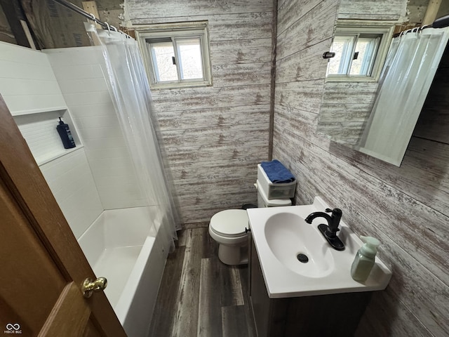 full bathroom with vanity, hardwood / wood-style floors, shower / bathtub combination with curtain, and toilet