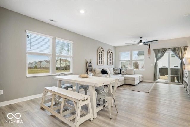 dining room with light hardwood / wood-style floors and ceiling fan