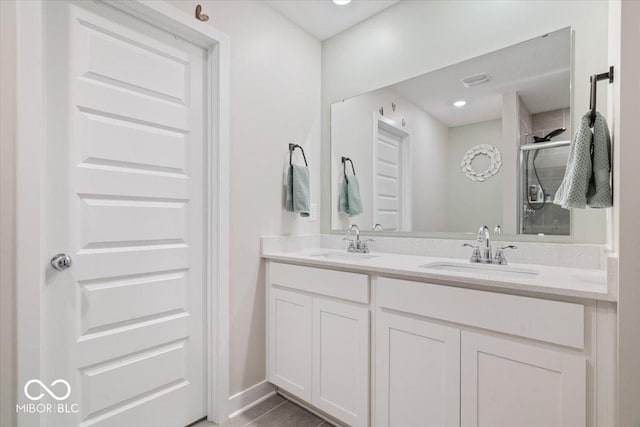 bathroom with vanity and a shower with shower door