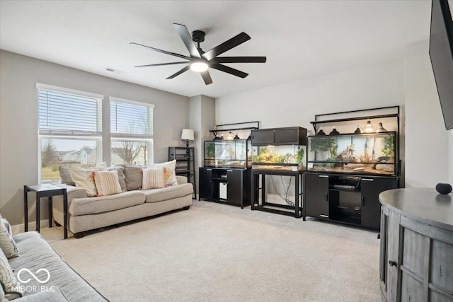 carpeted living room featuring ceiling fan