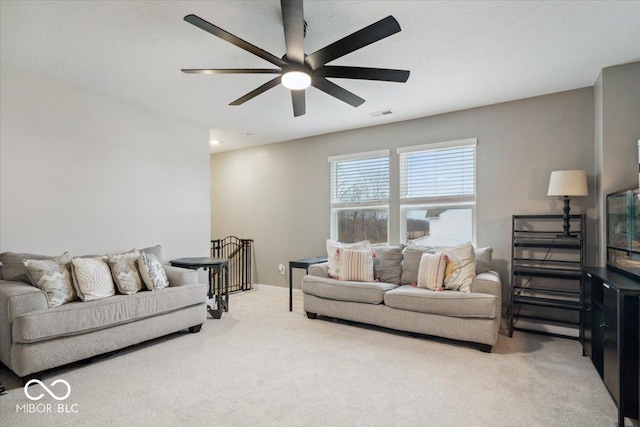 carpeted living room featuring ceiling fan