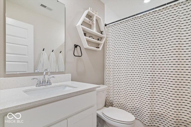 bathroom with vanity, toilet, and curtained shower