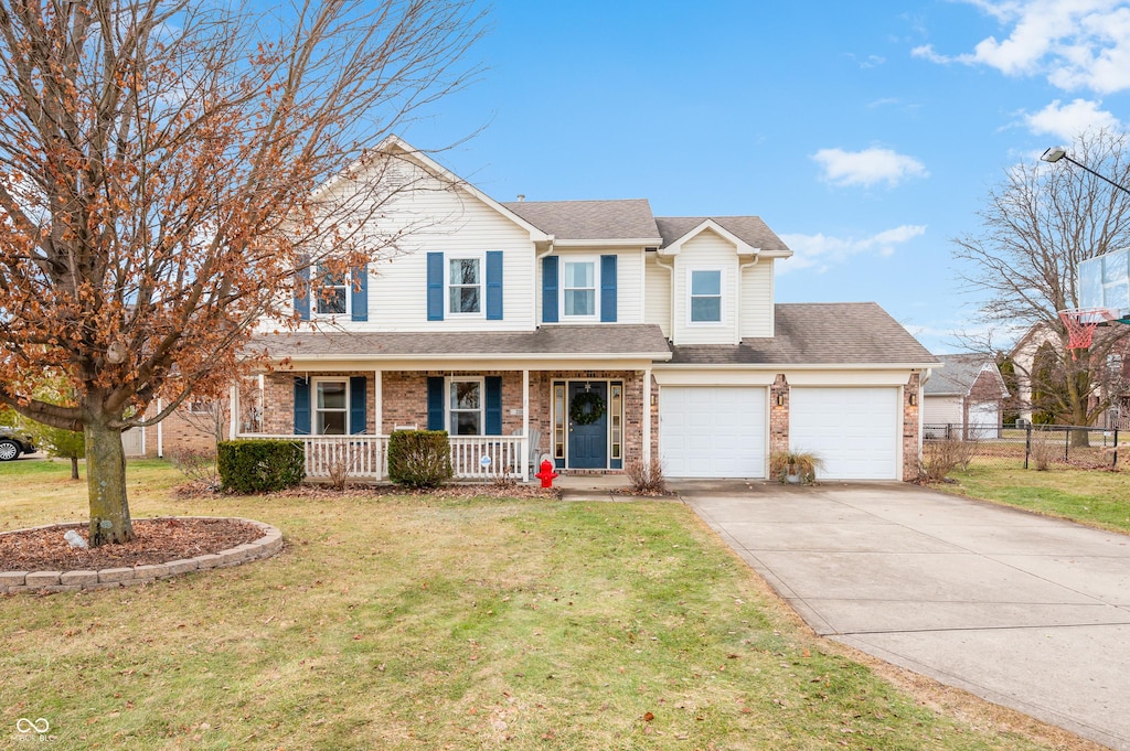 view of front of house with a front yard and covered porch