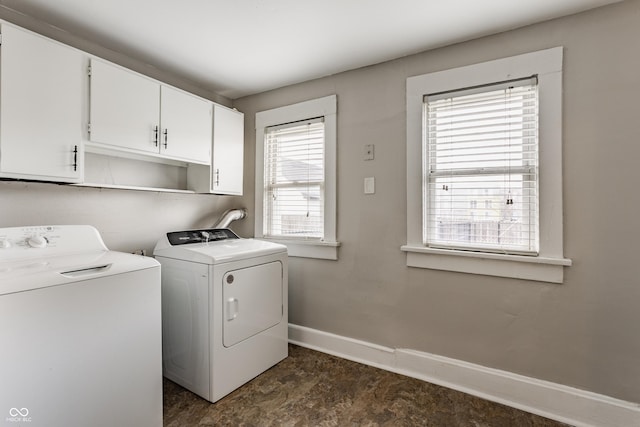 washroom with separate washer and dryer and cabinets