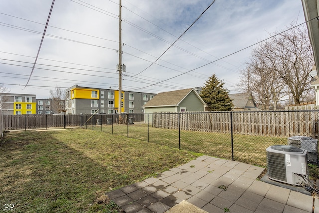 view of yard with central AC and a patio area