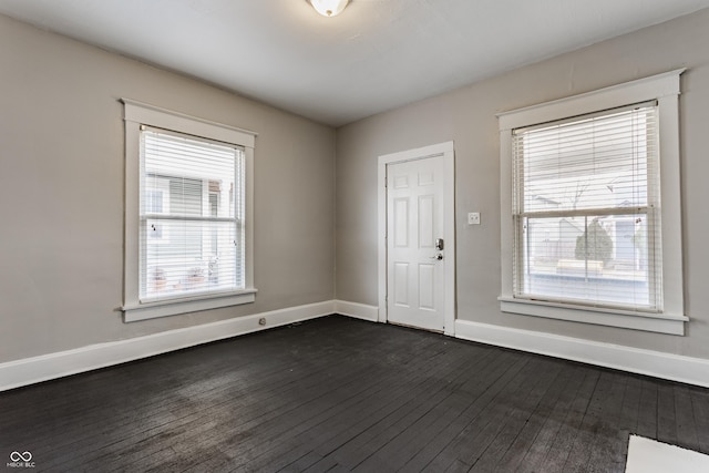 empty room featuring dark hardwood / wood-style flooring