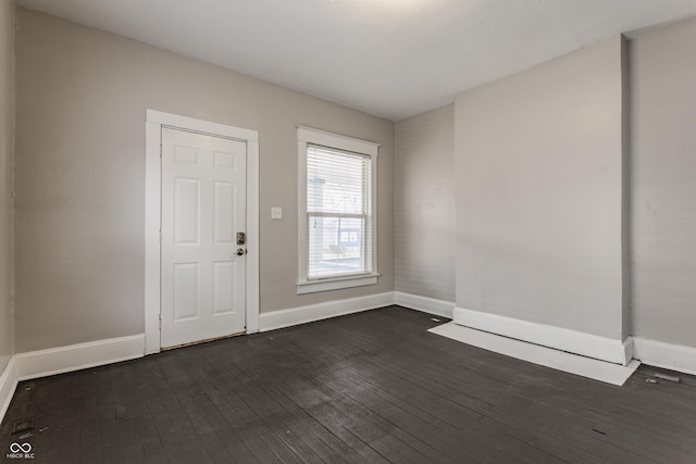 unfurnished room with dark hardwood / wood-style floors