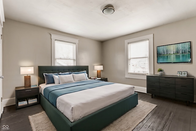 bedroom featuring dark hardwood / wood-style floors and multiple windows