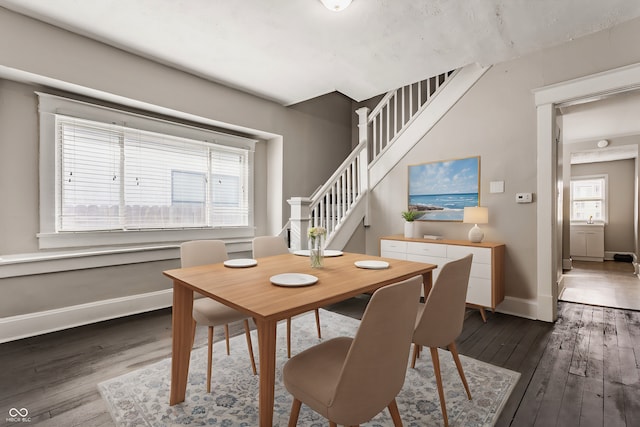 dining space featuring a healthy amount of sunlight and dark hardwood / wood-style flooring