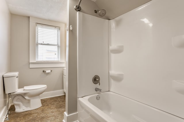 bathroom featuring shower / tub combination and toilet