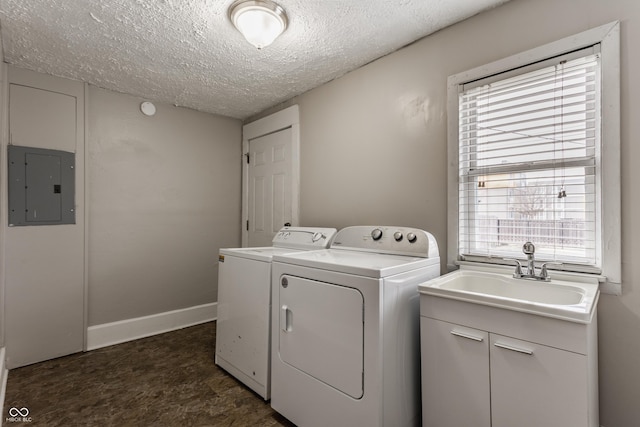 laundry room with sink, electric panel, independent washer and dryer, and a textured ceiling