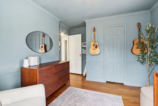 interior space featuring wood-type flooring and ornamental molding