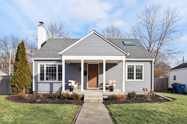 bungalow-style house with a front yard and covered porch