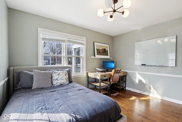 bedroom with dark wood-type flooring and a chandelier