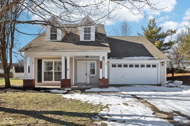 new england style home featuring a garage and covered porch