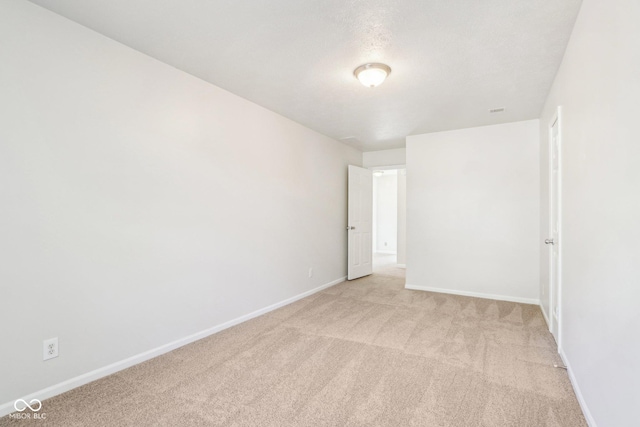 empty room featuring light carpet