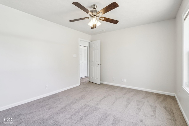 empty room with light colored carpet and ceiling fan