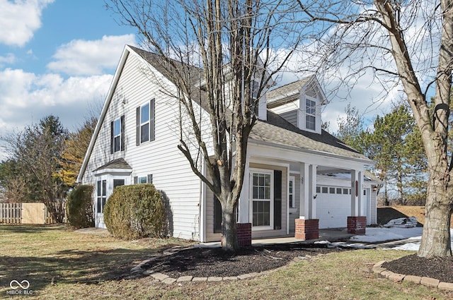 cape cod-style house with a garage and a front lawn