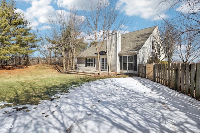 snow covered property featuring a lawn