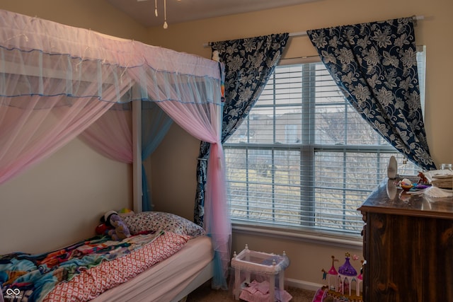 bedroom with carpet floors and vaulted ceiling