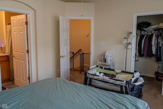 bedroom with light carpet, a spacious closet, and a closet