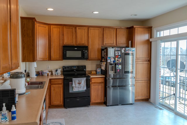 kitchen with sink and black appliances