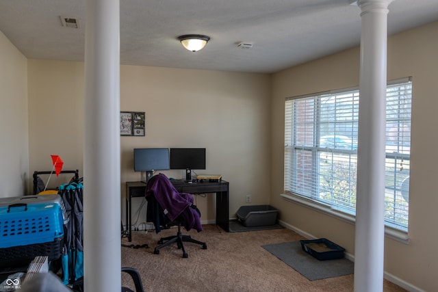 office featuring ornate columns and carpet flooring