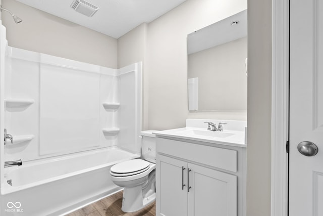 full bathroom featuring vanity, hardwood / wood-style floors, bathing tub / shower combination, and toilet