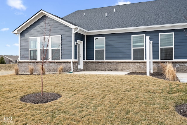 rear view of property with a patio and a lawn