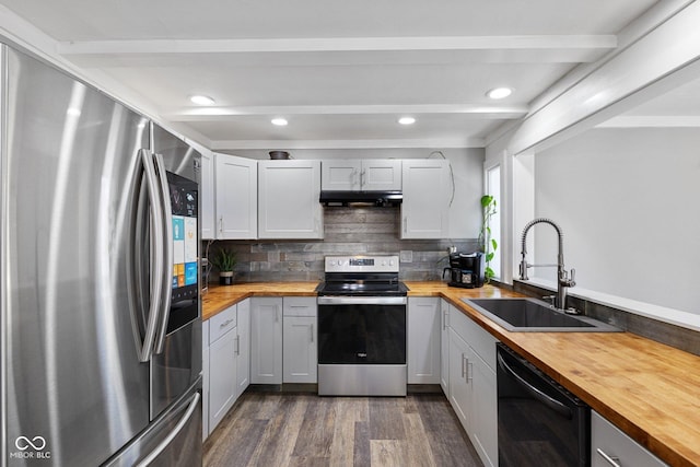 kitchen with beamed ceiling, stainless steel appliances, sink, and butcher block countertops