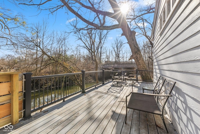 wooden deck with a water view