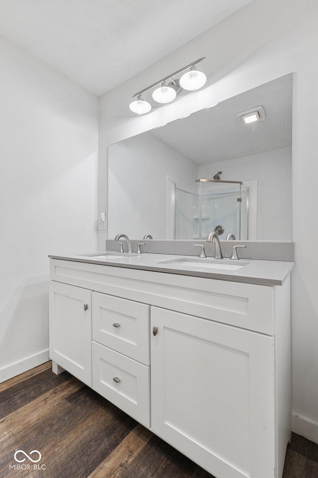 bathroom with vanity, hardwood / wood-style flooring, and walk in shower