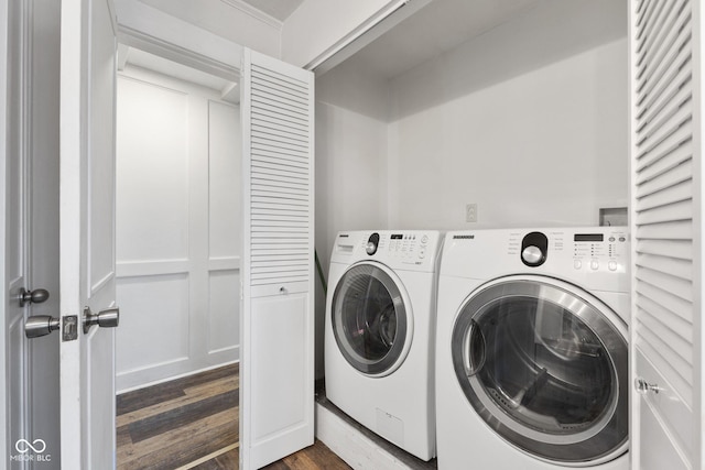 laundry area featuring dark hardwood / wood-style flooring and washing machine and dryer