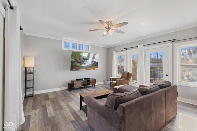 living room featuring ceiling fan, wood-type flooring, and a healthy amount of sunlight