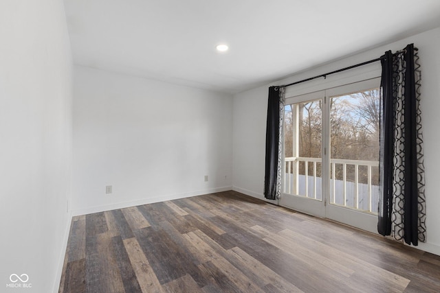 spare room featuring wood-type flooring