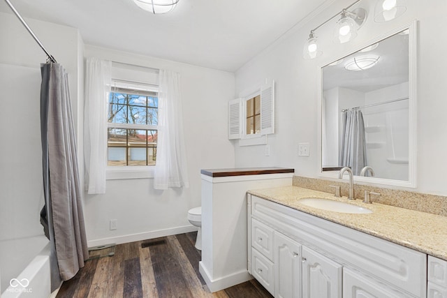 full bathroom featuring wood-type flooring, shower / tub combo with curtain, vanity, and toilet