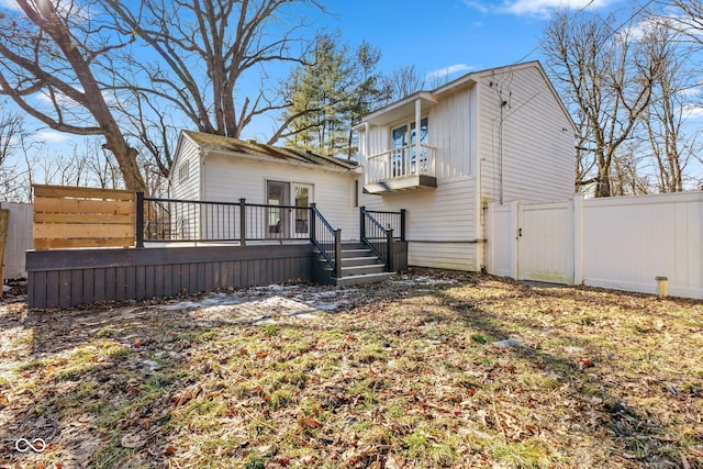 rear view of house with a balcony and a deck