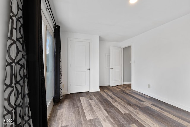 unfurnished bedroom featuring dark hardwood / wood-style flooring