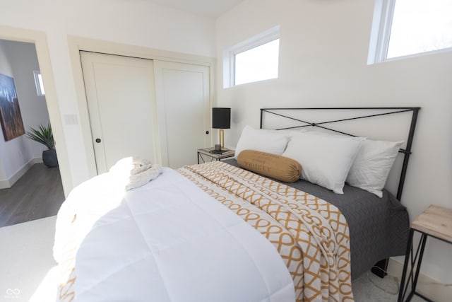 bedroom with hardwood / wood-style floors and a closet