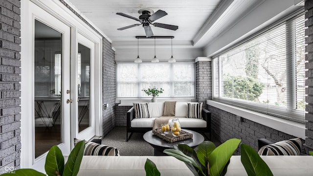 sunroom / solarium featuring ceiling fan