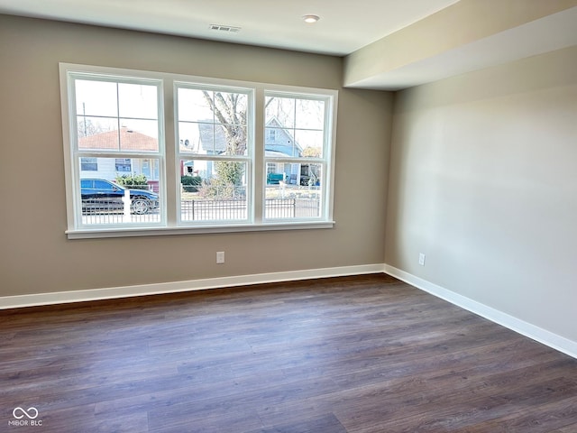 unfurnished room featuring dark hardwood / wood-style flooring