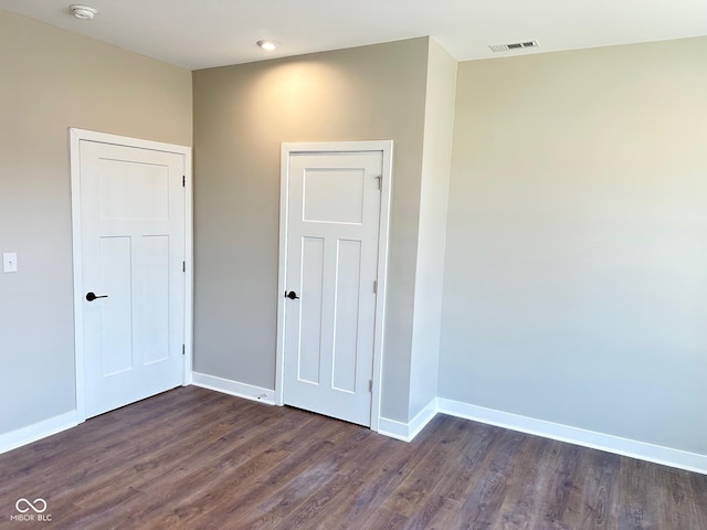 empty room with dark wood-type flooring