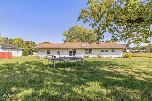 rear view of property featuring a yard