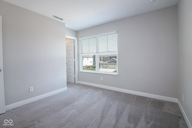 unfurnished room featuring baseboards, visible vents, and carpet floors