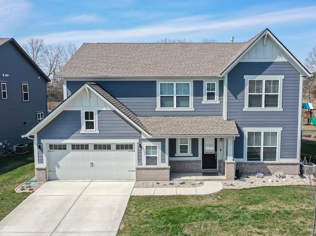 view of front of property featuring a front yard, brick siding, board and batten siding, and roof with shingles