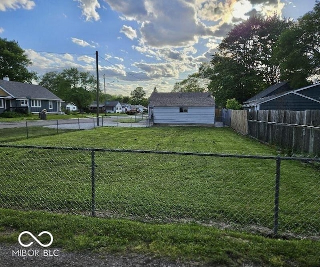 view of yard featuring an outbuilding and a fenced backyard