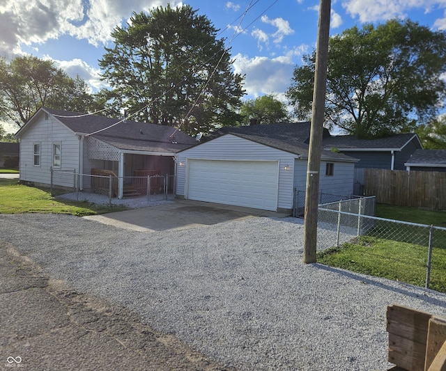 garage with fence and driveway