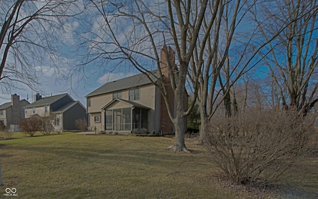 view of front of house with a front lawn and a sunroom