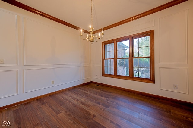 spare room featuring dark hardwood / wood-style flooring and a chandelier